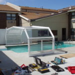 Retractable pool enclosure for a hotel